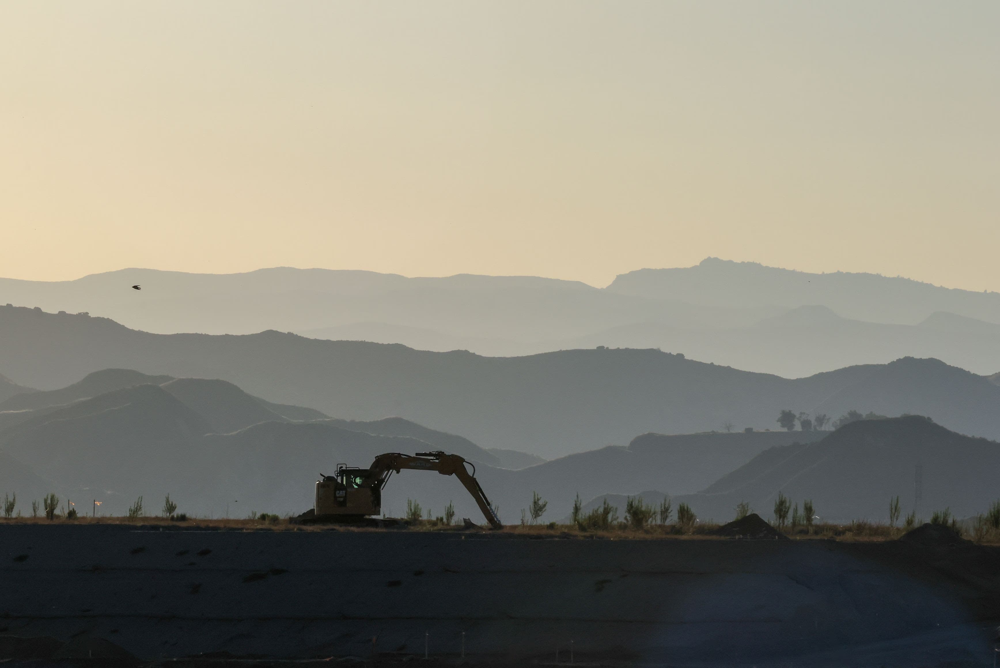 Real ground development progress and excavation at Nirvaana Hills with Aravalli mountains background